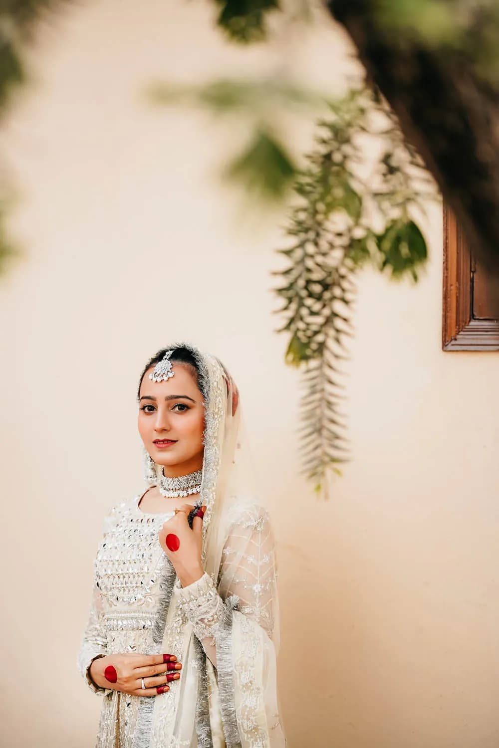 Bride in ivory beneath hanging greenery