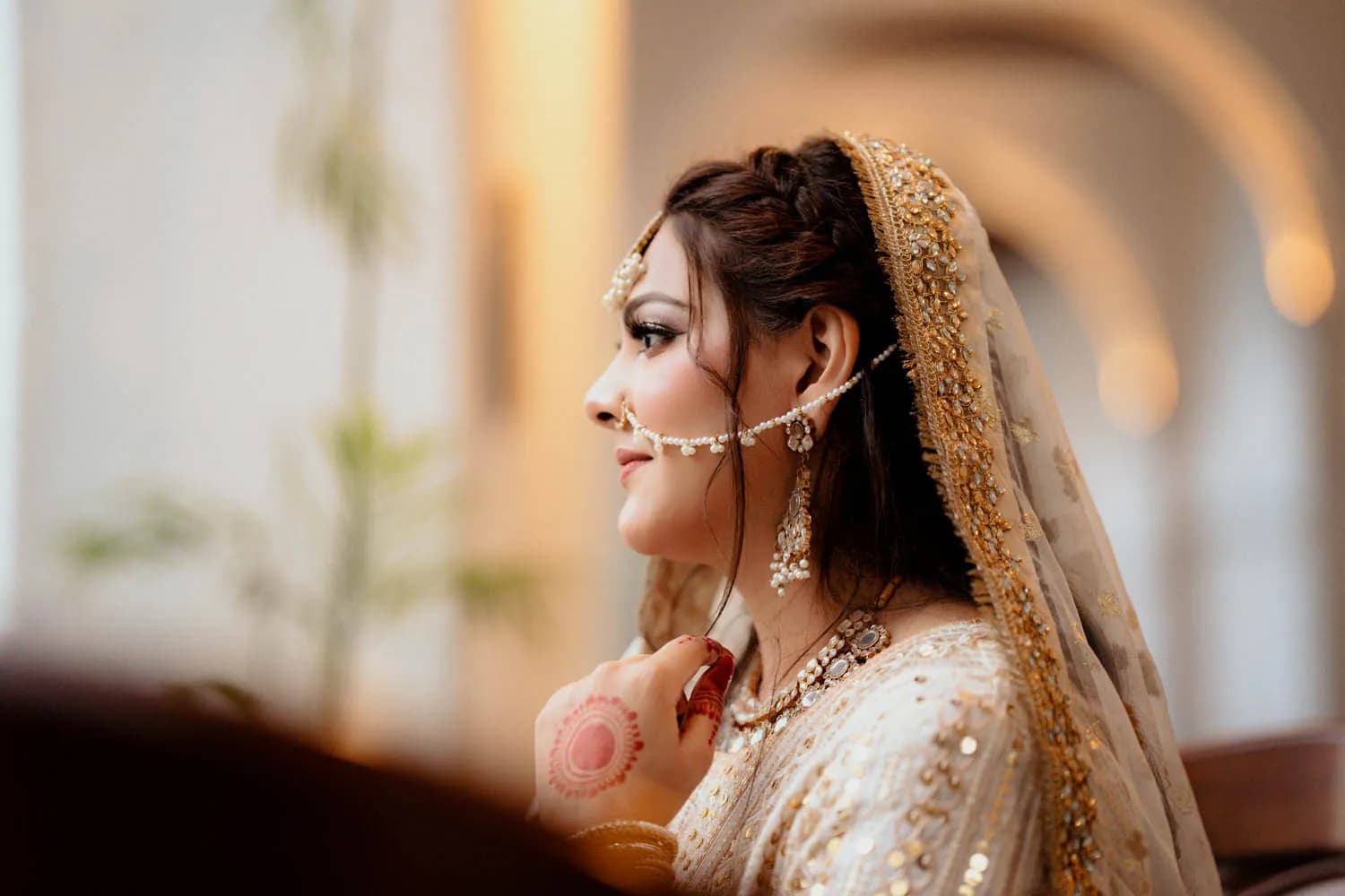 Bride in profile wearing a nose ring and gold jewellery
