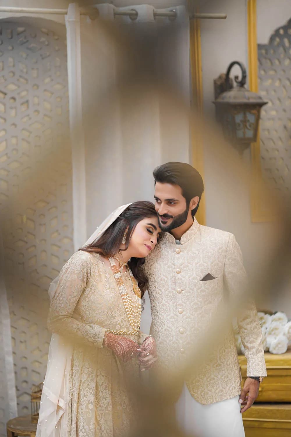Couple framed through a soft foreground