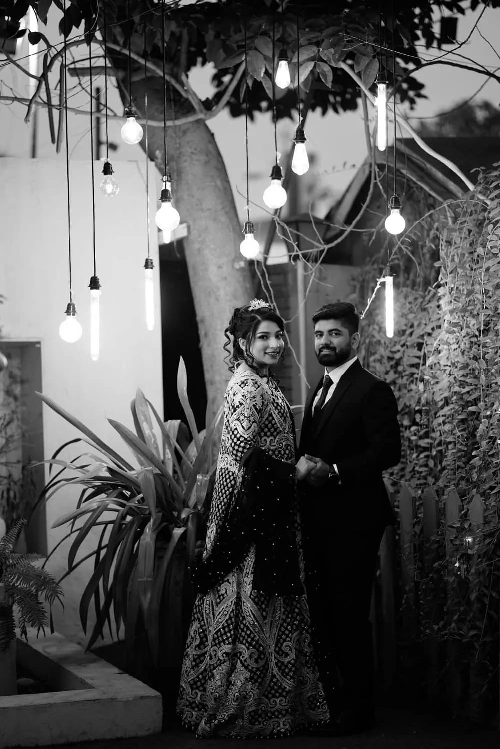 Black and white couple portrait under string lights
