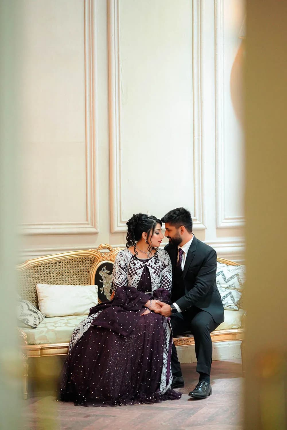 Couple seated in a softly lit cream room