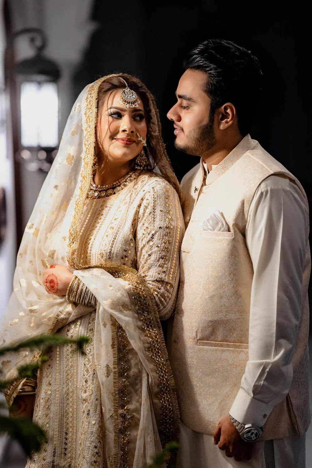 Bride and groom posed in gold and cream