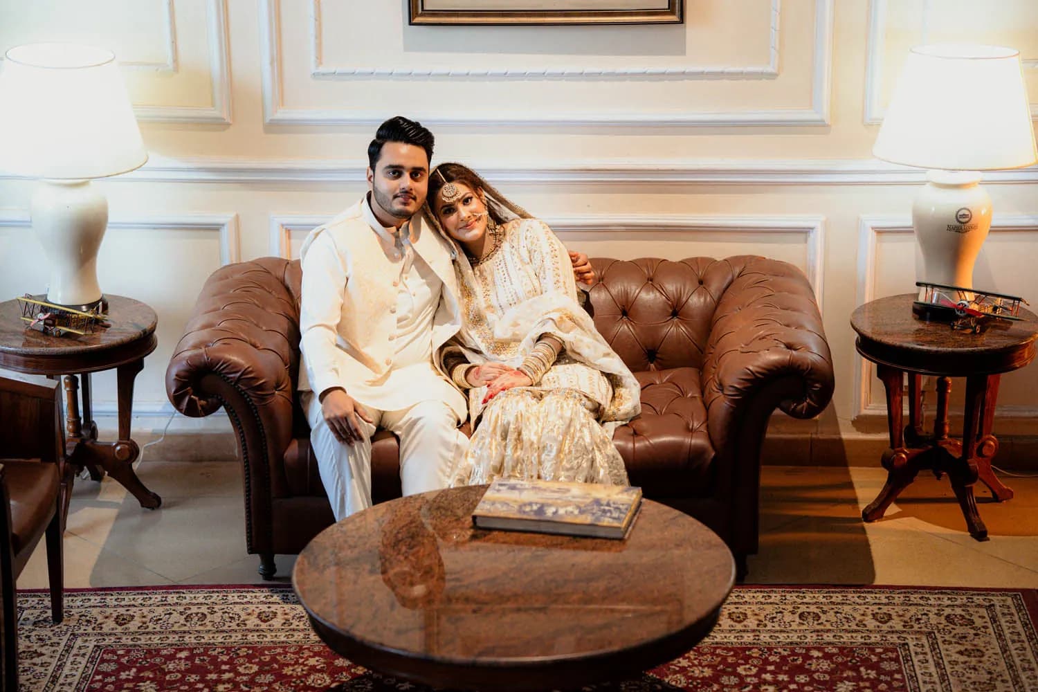 Couple seated in a classic leather lounge