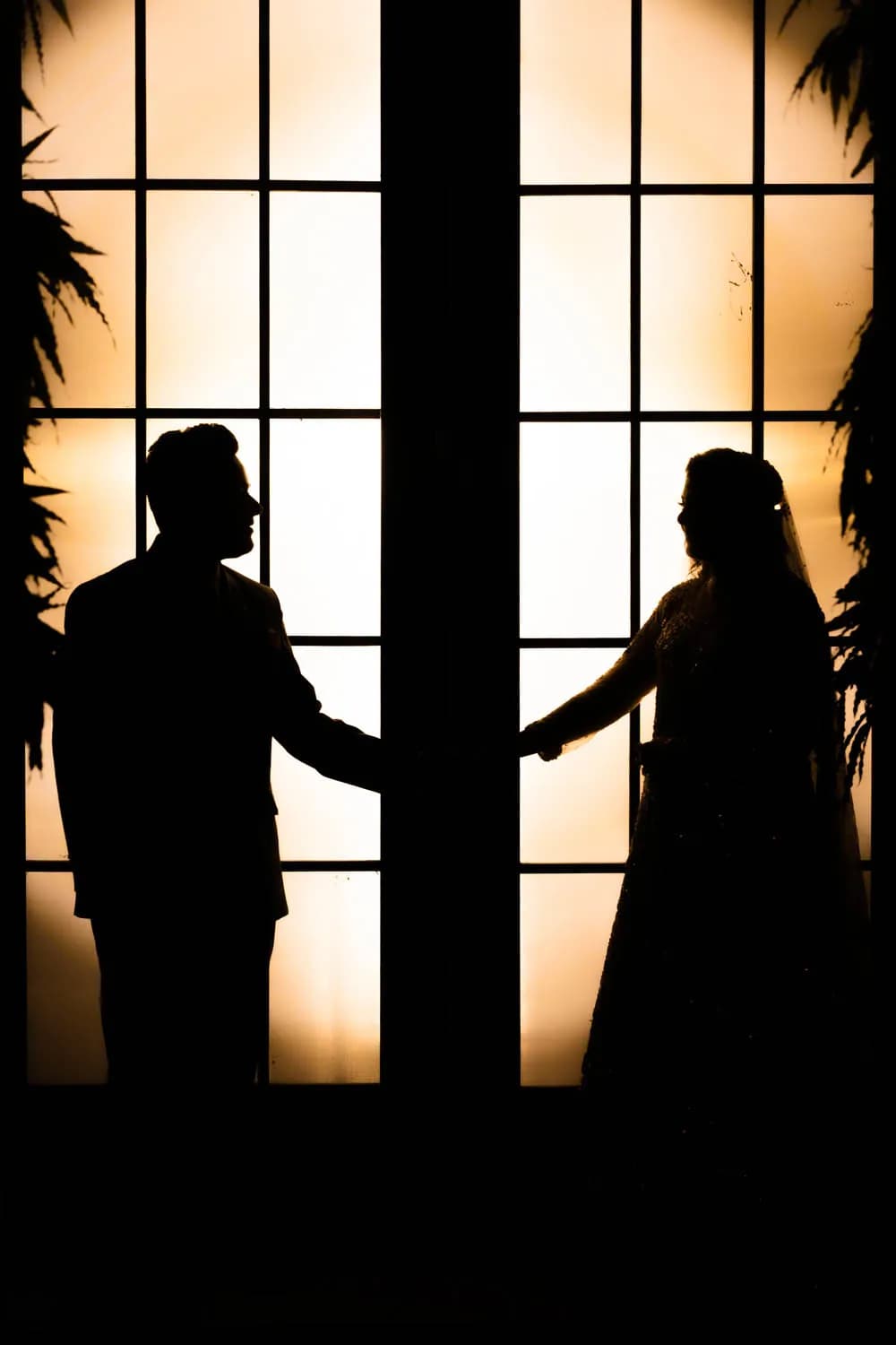 Silhouette of a couple against a glowing doorway